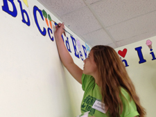 Kendall Whitehead ’16 of Easton puts the finishing touches on a mural at South Side II Head Start in Scranton. She, along with 42 other incoming students, arrived earlier than her classmates to volunteer at several nonprofit organizations as part of FIRST, a program now in its 10th year at The University of Scranton.